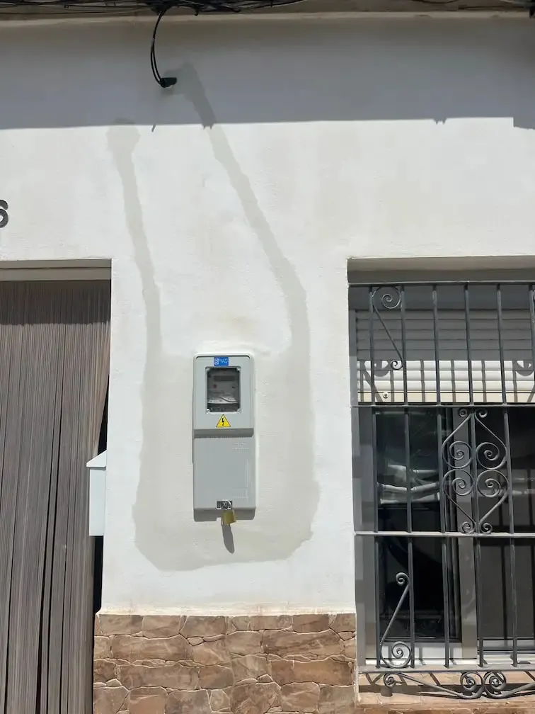 Electricity meter box on the front of a house