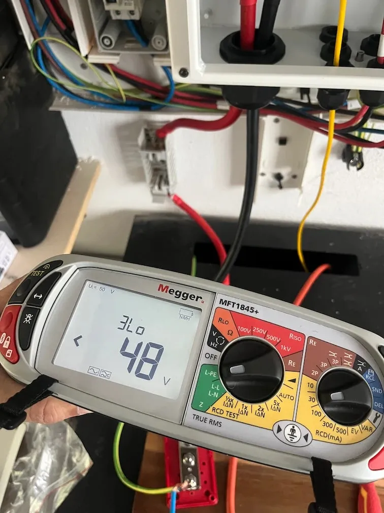 Electrical installation tester taking measurements in a consumer unit